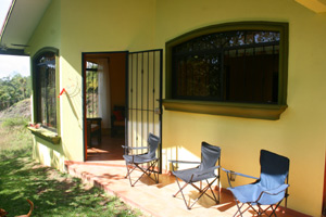 A covered patio overlooks the bird-rich forested valley.