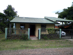 The front of the house is on a quiet village lane on the mountainside. There are fine lake and territorial views.