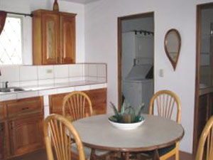 The kitchen is fully equipped with dishes and appliances.