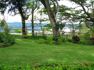 The basement apartment opens on landscaped grounds with a great view of Lake Arenal.