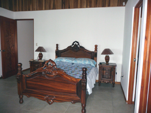 The master bedroom has a handsome matrimonial bed.