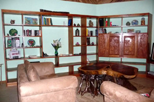 The living room has extensive shelving of fine hardwood.